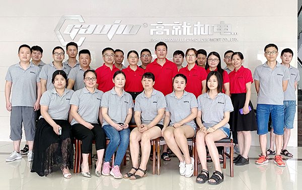 Gaojiu team photo in front of the logo wall
